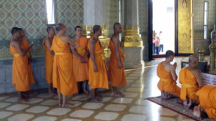 Monks paying their respects to the Buddha