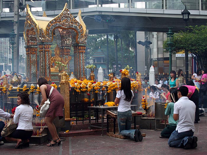 Worshippers at Erawan Shrine in Front of Grand Hyatt Erawan Hotel at Ratchaprasong Intersection